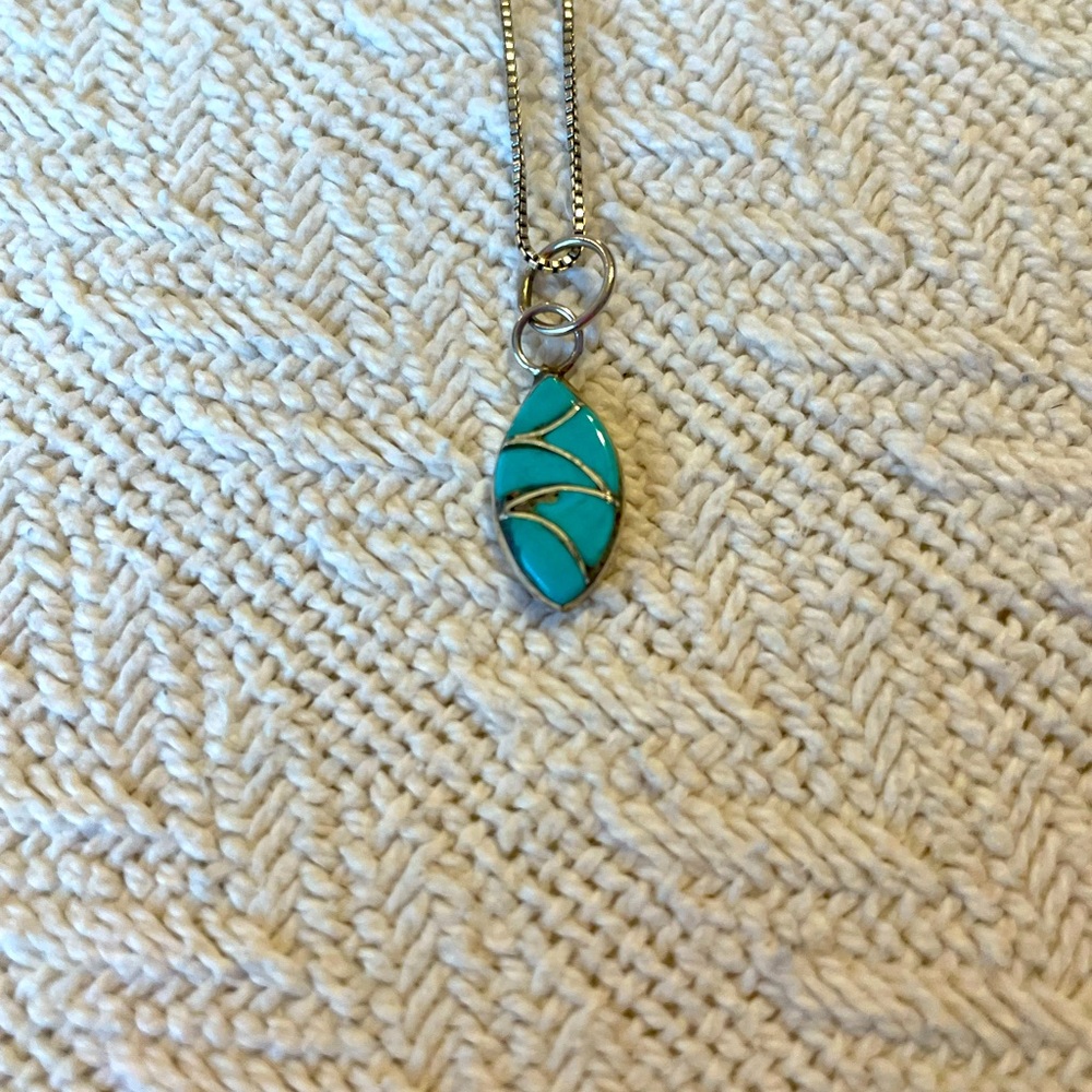 Hand made silver and turquoise charm on sterling silver necklace.